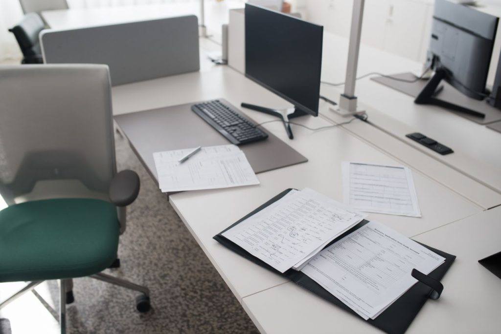 Organized document binder representing separate remediation passes for source and translated PDFs